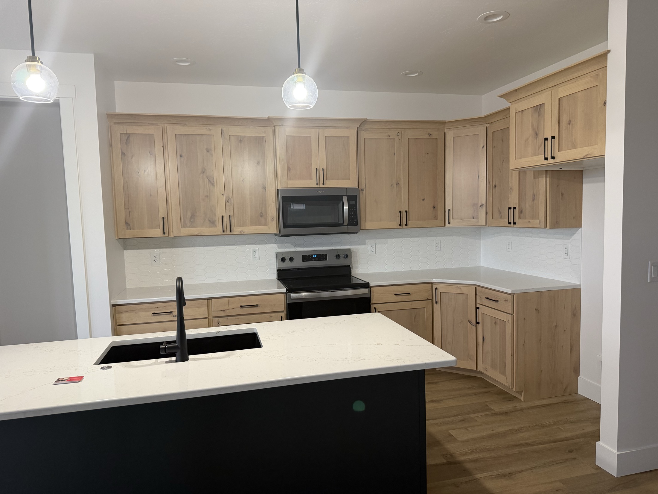 Knotty alder kitchen with navy island and white quartz